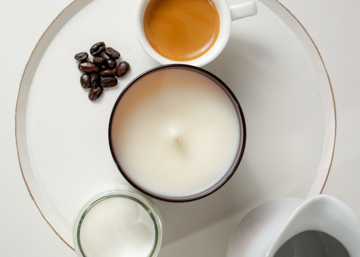 Vanilla Latte candle on a serving tray with espresso, coffee beans and creamer